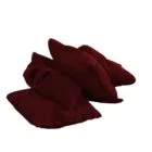 Maroon socks folded and placed on a white surface.