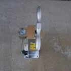 Handheld air pump on a concrete surface.