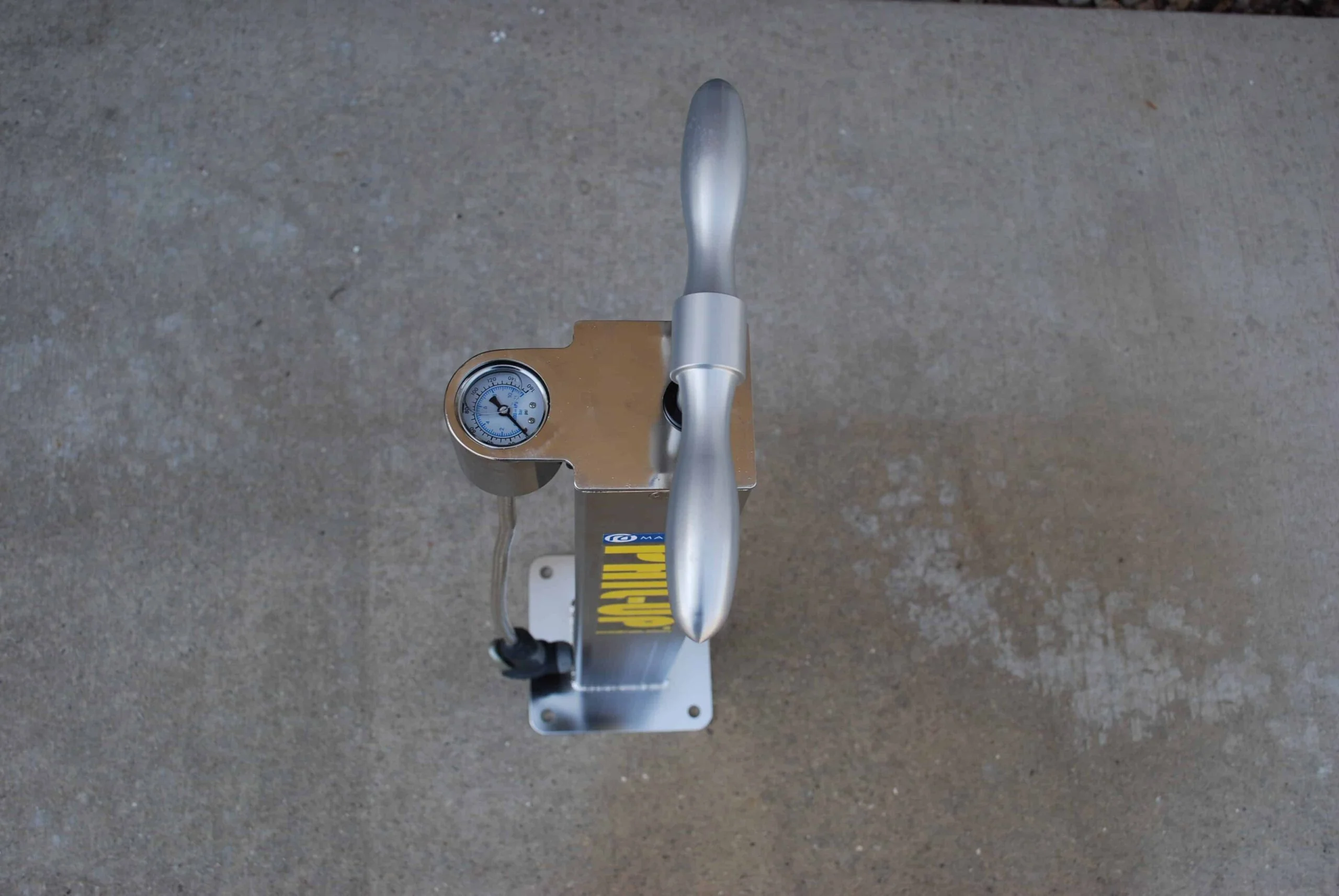 Handheld air pump on a concrete surface.