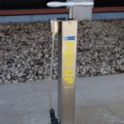Electric parking boot jack on a concrete surface.