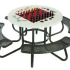 Round picnic table with chessboard top and black metal benches.