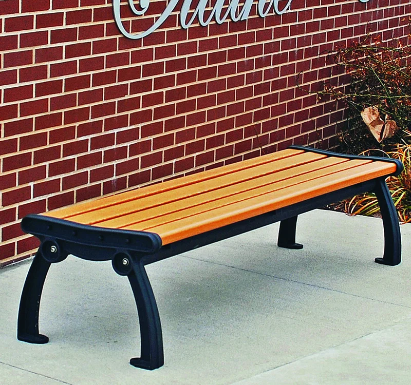 Outdoor bench against brick wall.