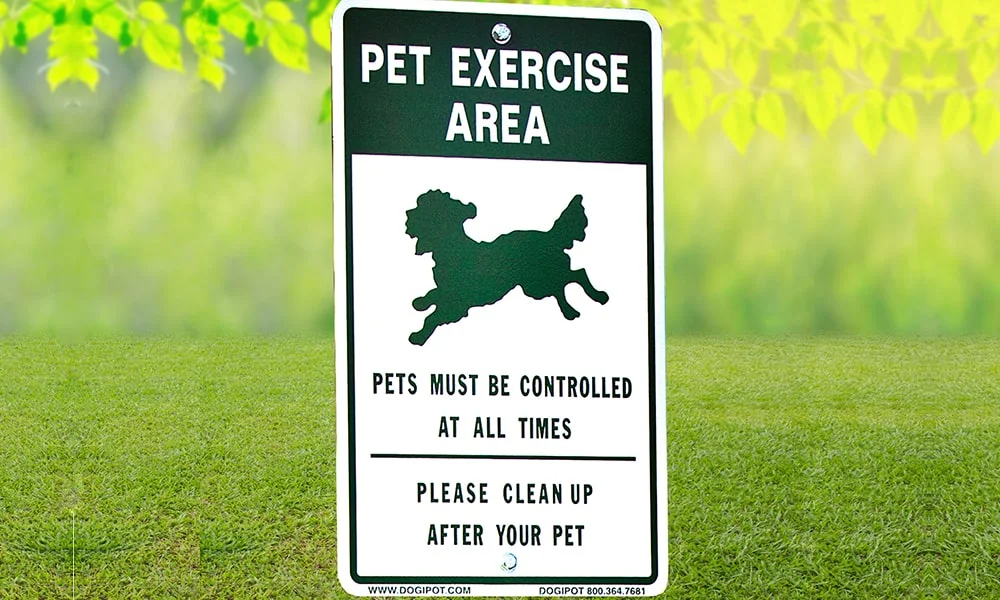 Pet Exercise Area sign on grass.