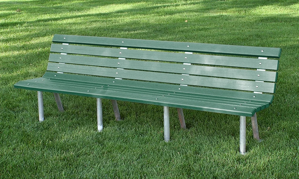 Green park bench on grass.