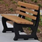 Modern outdoor bench with wooden slats and black legs.
