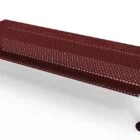 Red metal bench with armrests and holes in seat.