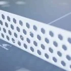 Close-up view of a perforated table tennis net.