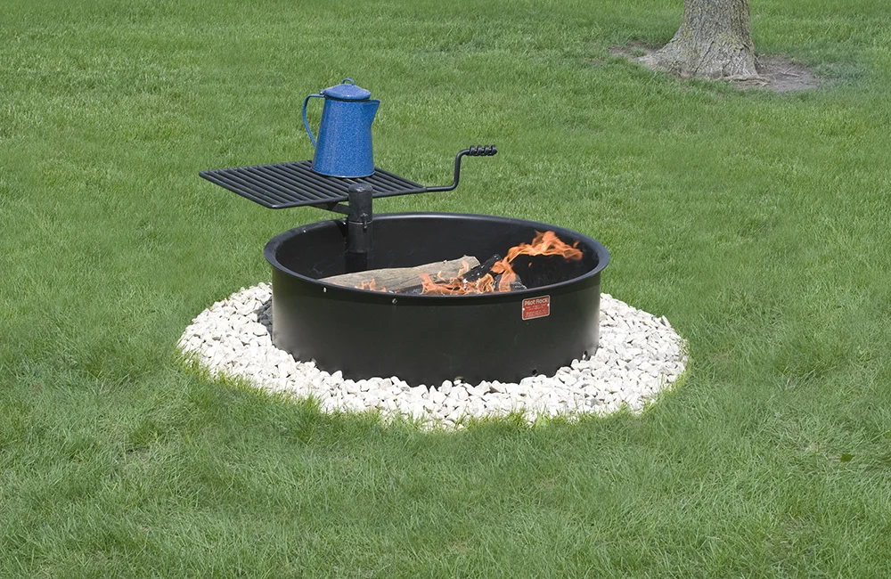 Fire pit with a blue kettle on top.