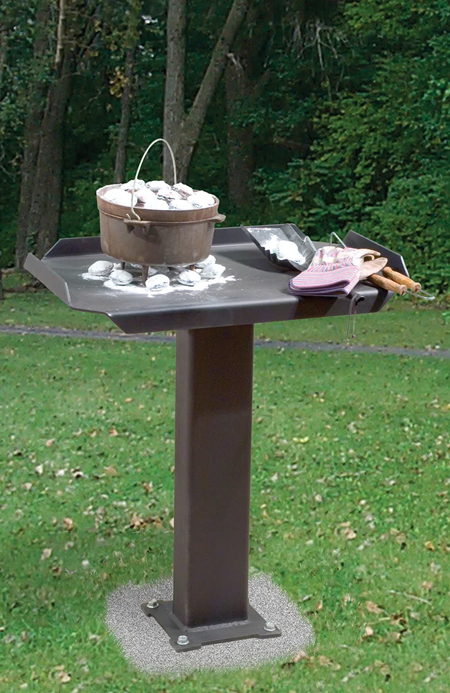Outdoor cooking setup on a stand in a park.