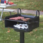 Portable grill on grassy outdoor area.