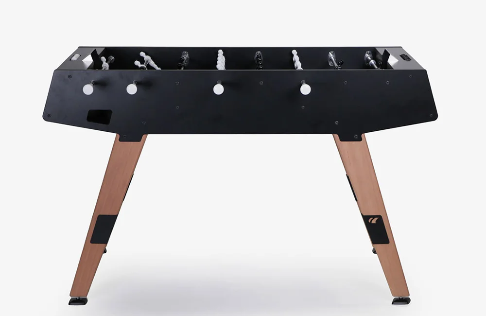 Foosball table with black top and wooden legs.