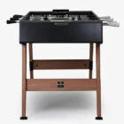 Foosball table with black top and wooden legs.