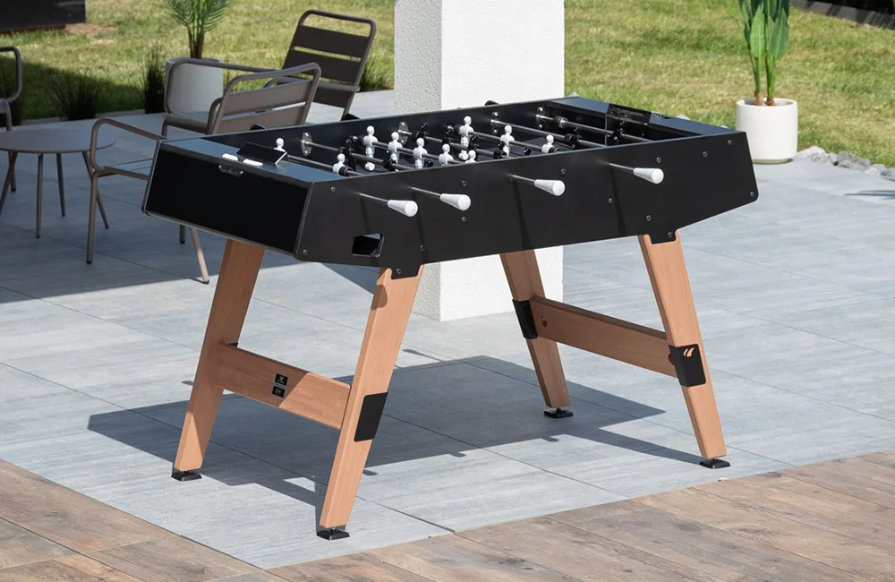 Outdoor foosball table on a patio.