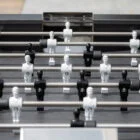 Foosball table with white and black figures.