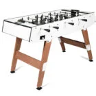 Foosball table with white top and wooden legs.