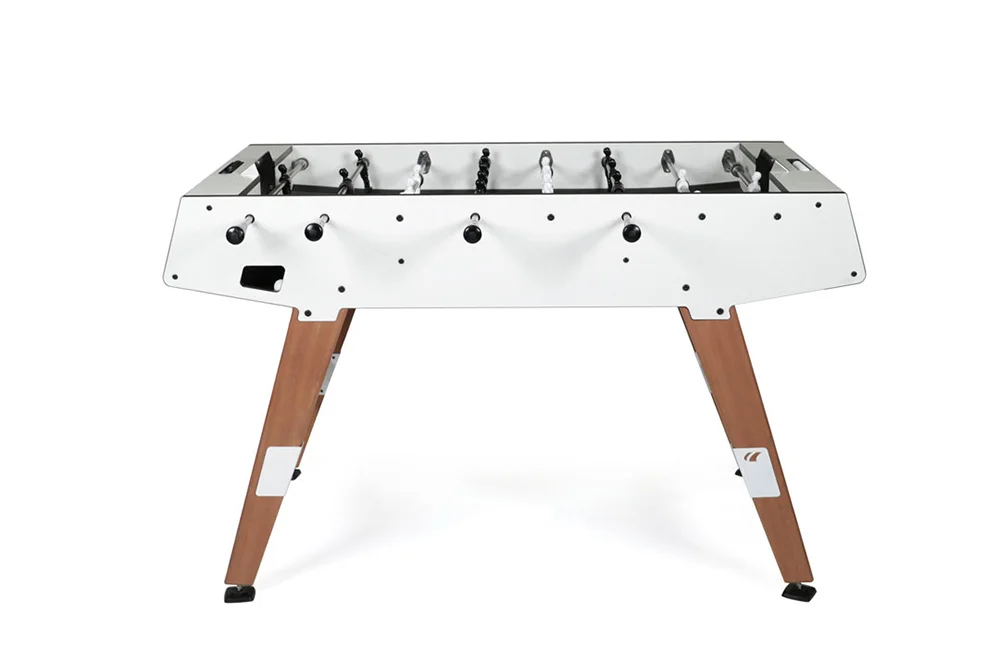 Foosball table with white top and wooden legs.