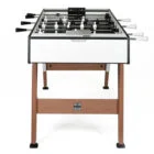 Foosball table with white and black playing surface.