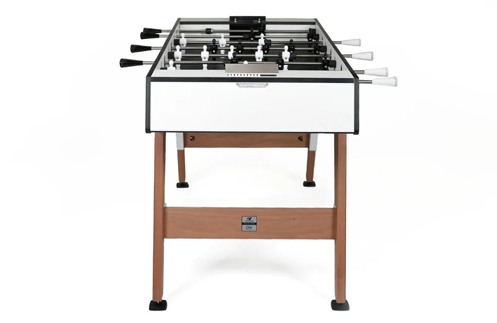 Foosball table with white and black playing surface.