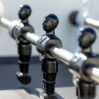Black metal figurines holding handles in a row.