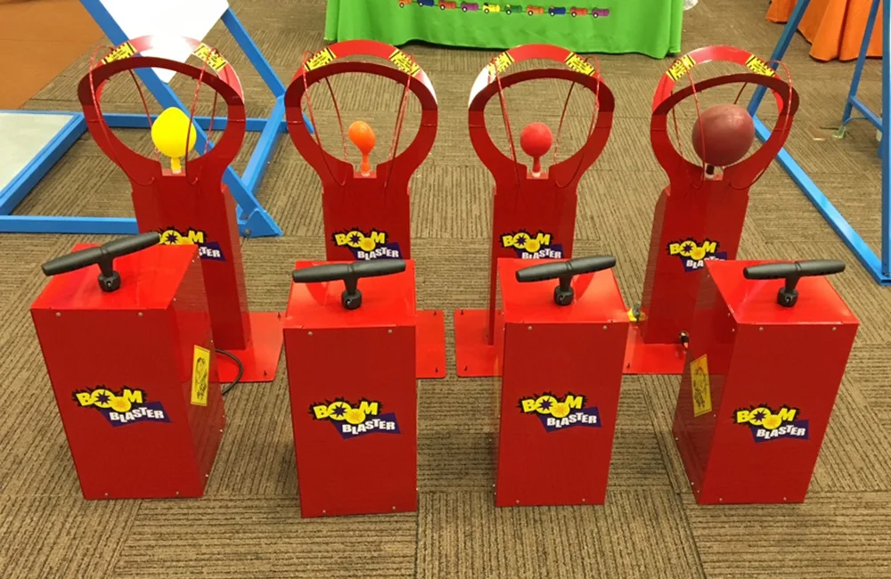 Red basketball arcade machines with handles and hoops.
