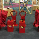 Red toy blasters and bags on a playground.