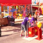 Children playing at an outdoor carnival game.