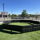 A black plastic structure on a green artificial turf field.