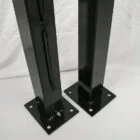 Black metal speaker stands on white background.