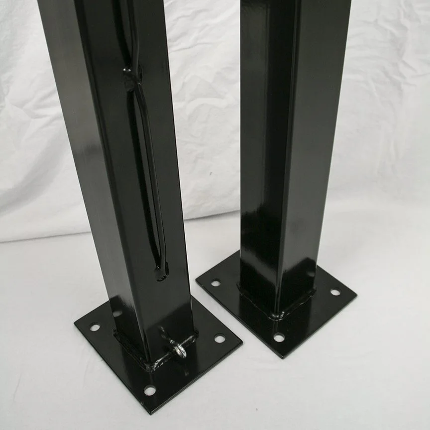 Black metal speaker stands on white background.