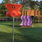 Playground equipment and slide in a park setting.
