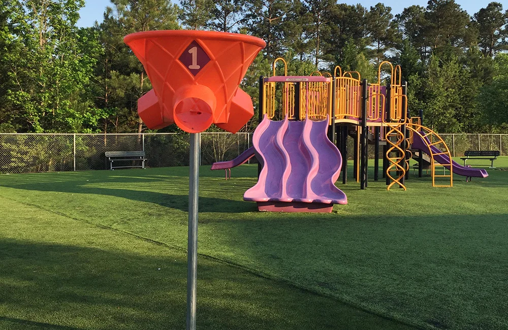 Playground equipment and slide in a park setting.