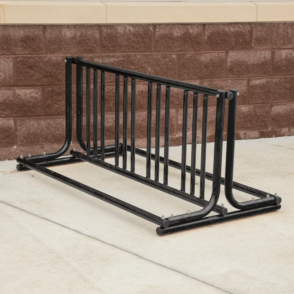 Black metal bike rack on concrete sidewalk.