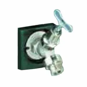 Water faucet handle and spout on a green wall.