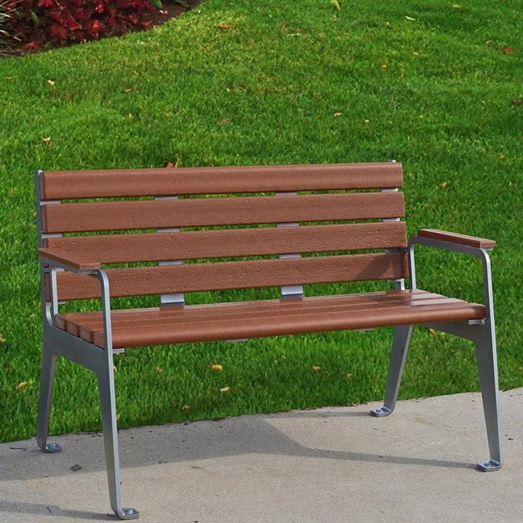 Wooden bench on concrete path in park.