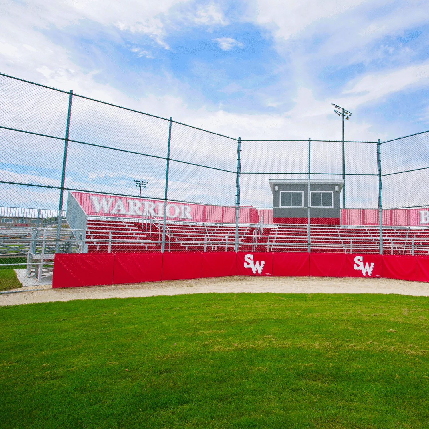 8rowelevated13r Baseball field with red bleachers and Warrior sign.