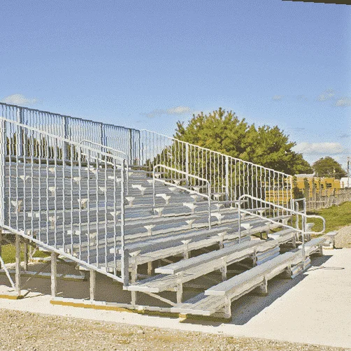BLA10A27V4F448AHR Stadium bleachers with metal railings and wooden seating.