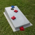 Cornhole board on grass.