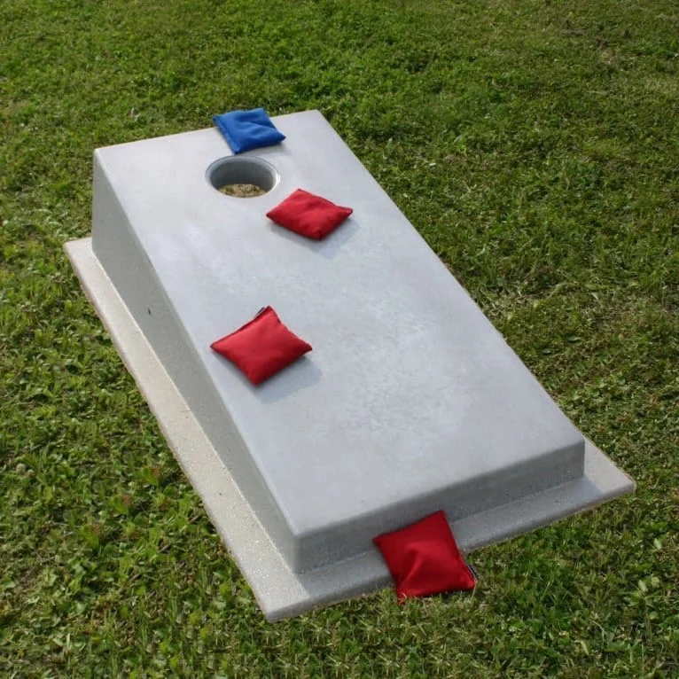 Cornhole board on grass.