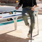 Man playing pool on a white table.