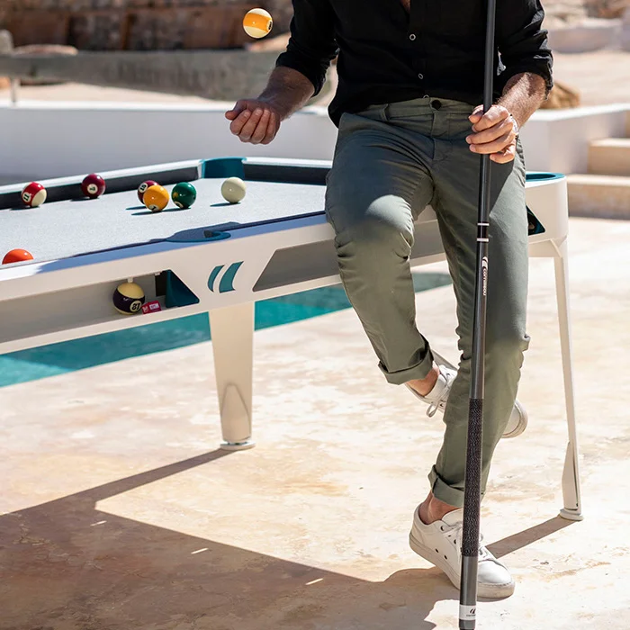 Man playing pool on a white table.