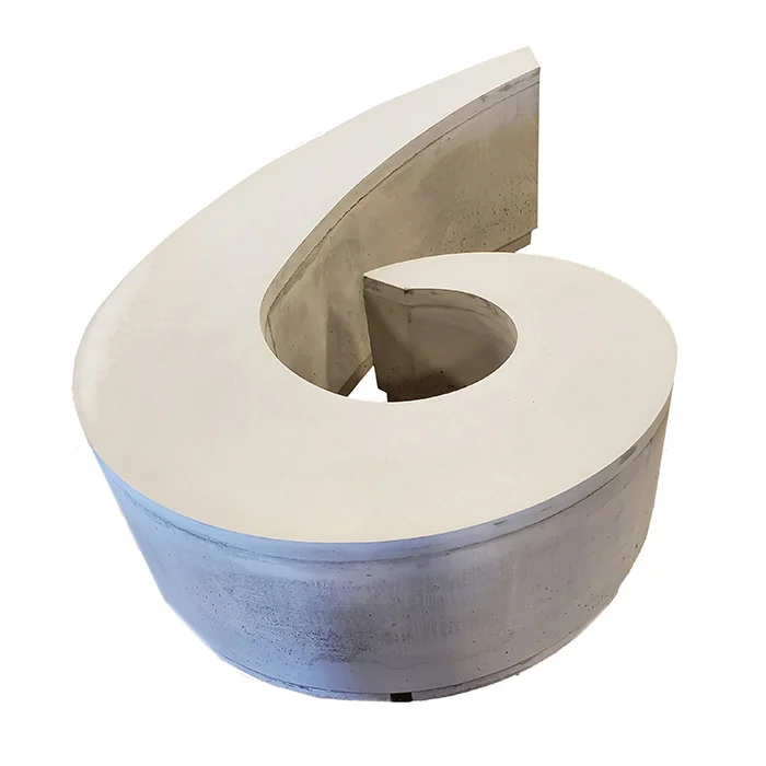Concrete toilet paper holder with a hole in it.
