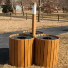 Wooden trash cans in a park setting.
