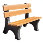 Wooden park bench with black and gray legs.