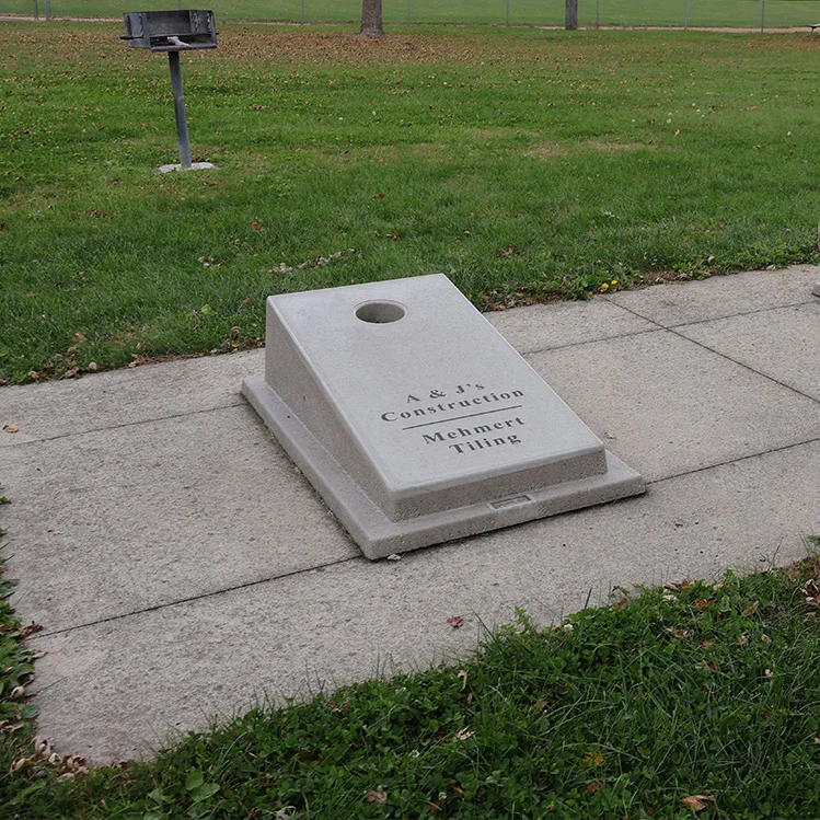 Concrete plaque on sidewalk in park.