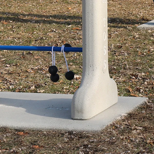 Pole with blue bar and black pom-poms hanging from it.