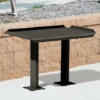 Black metal table on a sidewalk.