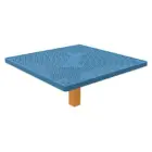 Blue perforated table top on wooden leg.