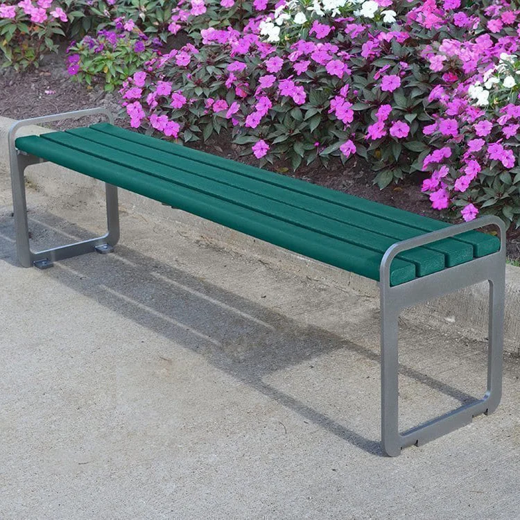 PB-6GRESFPLZBAC Green bench on concrete pavement near colorful flowers.