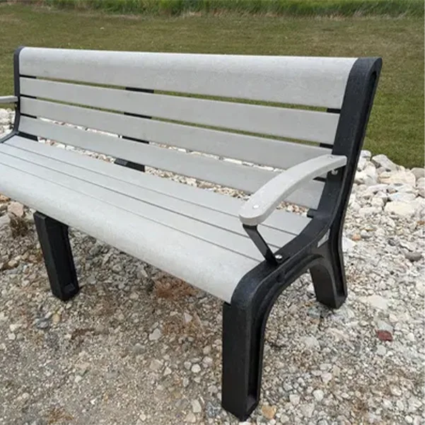 Park bench with white slats and black armrests.