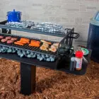 Outdoor grill cooking various food items.